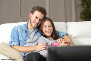 Couple sitting on the couch watching a movie