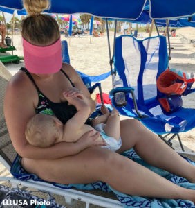 Feather nursing her son at the beach